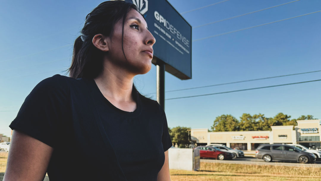 Lisa Iturri, Director of Operations at GPI Defense, standing in front of the GPI Defense office after a heroic rescue from a burning car