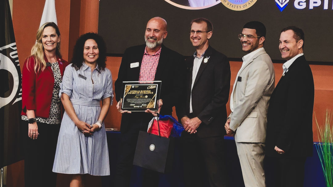 GPI Defense receiving the Veteran Business Award of Excellence on stage at the Houston Regional Veterans Chamber of Commerce Awards.