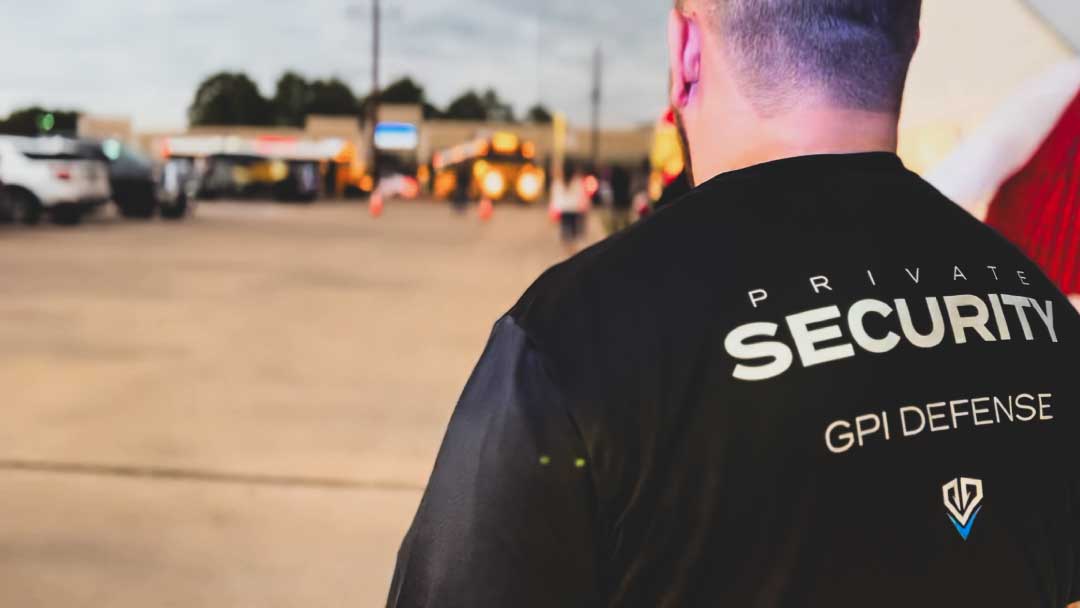 A GPI Defense security professional overseeing a holiday event with police officers and children in need, ensuring safety and fostering community spirit.