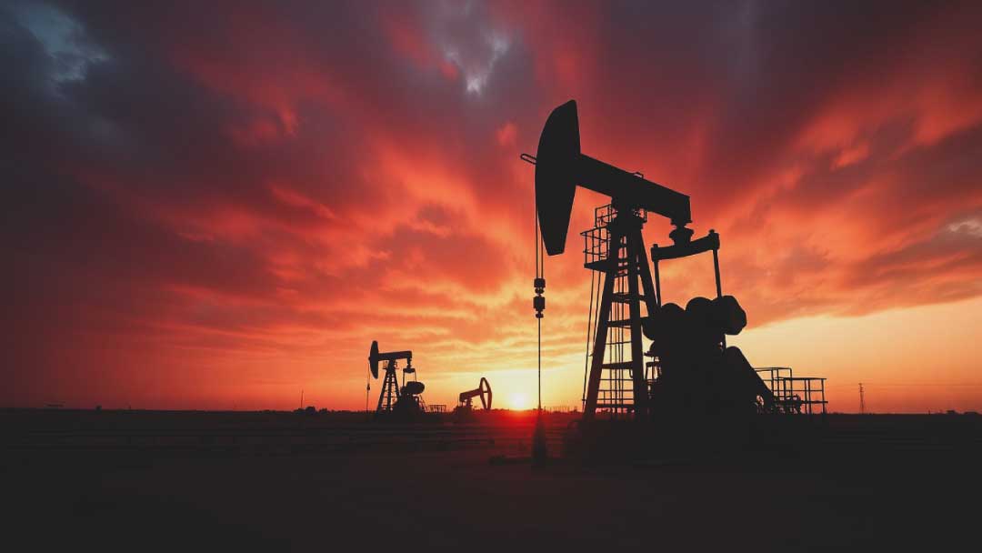 Panoramic view of Texas oil and gas operations showcasing oil pump jacks at sunset, highlighting risk mitigation for global oil and gas operations.